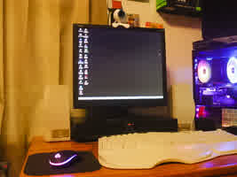 A picture of my Windows 98 setup, featuring my main PC to the side