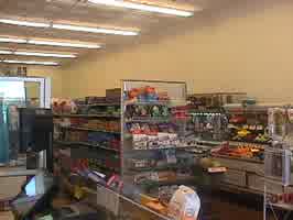 The inside of a grocery store, with high ceilings and warm fluorescent lighting.