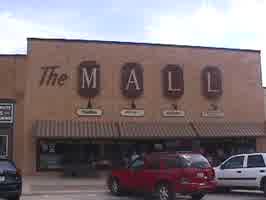 The outside of the shopping center, with a large sign reading 'The Mall' on the front of the building.
