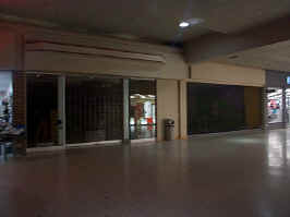 Two closed storefronts in the northeast wing of the mall. Label scarring is not visible.
