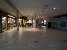 Down the Target wing of the mall. To the sides are a western wear store, a nail salon, and an empty store. Target is at the end of the hall.