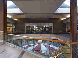 The south Dillards court in the Oak Park Mall from the 2nd floor. A carousel is visible on the 1st floor, with the brick building containing Dillard's in the background.