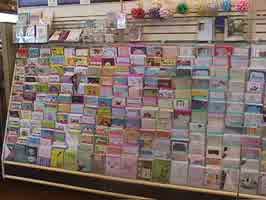 A shelf with greeting cards.