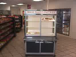 A cabinet with a sign reading 'Fresh Baked Pastries'. The cabinet is mostly empty.
