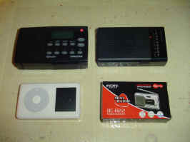 A photo comparing the size of four objects. Top left is the Sangean HDR-14  and top right is the Sony ICF-P26, similar in size. Bottom left is an iPod and bottom right is the box for the Indin BC-R22, about 80% the size of the top receivers.